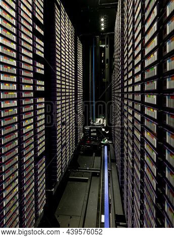 Data center with multiple rows of fully operational server racks. modern cloud computing technology concept.
