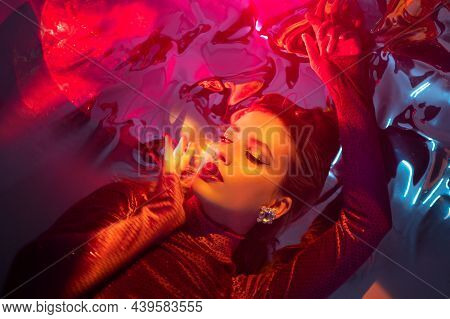 Portrait Of A Young Beautiful Woman On A Shimmering Background, Iridescent Colored Light, Futuristic