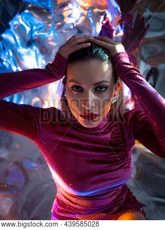Portrait Of A Young Beautiful Woman In A Stylish Scarlet Dress On A Shimmering Background, Iridescen