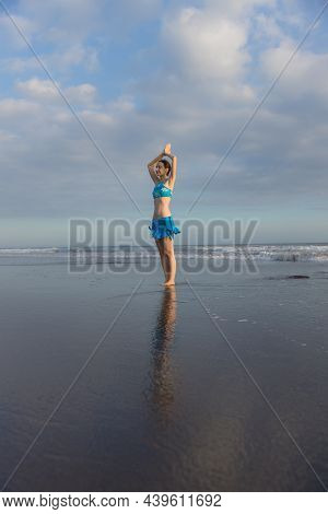 Yoga Pose. Vrikshasana Asana. Young Woman Practicing Tree Pose At The Beach Near The Ocean During Su