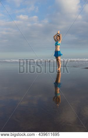 Yoga Pose. Vrikshasana Asana. Young Woman Practicing Tree Pose At The Beach Near The Ocean During Su