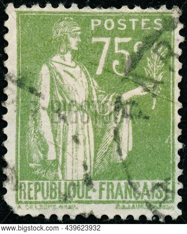 Vintage Stamp Printed In France Circa 1932 Shows Antique Character With Olive Branch