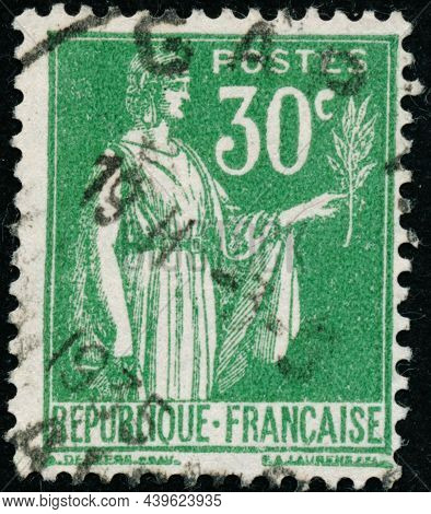 Vintage Stamp Printed In France Circa 1932 Shows Antique Character With Olive Branch