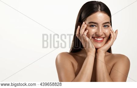 Skin Care And Women Cosmetics. Smiling Young Woman With Clean, Glowing Facial Skin, Touching Her Fac