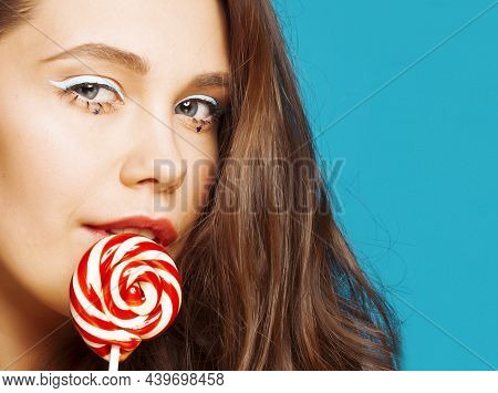 Young Pretty Adorable Brunette Woman With Curly Hair Closeup Like Doll Makeup On Blue Background, Po