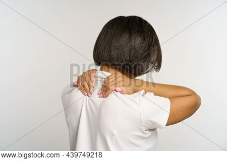 Woman Suffer From Neckpain After Long Office Work At Computer, Massage Neck To Relief Muscle Strain.