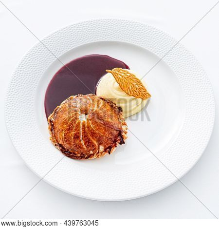 Tenderloin with pork, mushrooms and sirloin puff pastry on a white background. Homemade meal for wellington.