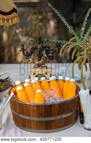 Orange Juice Bottle Ice Cold. Orange Juice In Plastic Bottle In Ice For Sale In Street Food Market. 