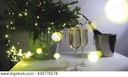 New Years Celebration Of Couple With Champagne. Two Tall Glasses With Bubbles Of Sparkling Wine. Gol