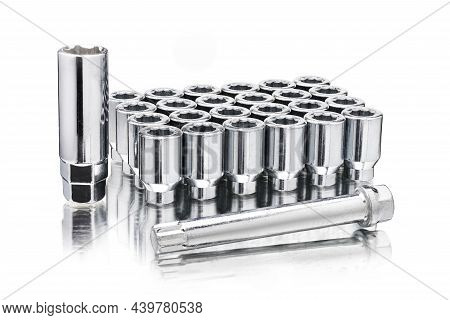 A Set Of Chrome-plated Wheel Nuts, Wheel Ten-beam Nuts And A Key Adapter, Isolate On A White Backgro