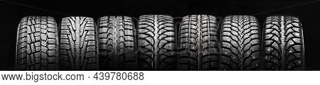 A Lot Of Winter Studded Tires And Velcro Tires Stand In A Row On A Black Background Panorama
