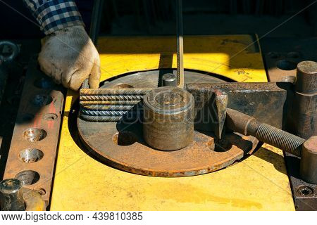 Rebars With Rebar Bending Machine In The Site. Worker Using Bending Rebar Machine For Reinforcement 