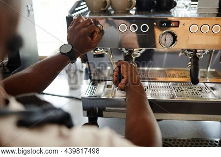 High Angle Shot Of Unrecognizable Barista Adjusting Settings On Professional Coffee Machine For Maki
