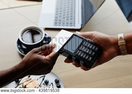 High Angle Close-up Shot Of Unrecognizable Man Sitting At Table In Modern Cafe Paying For Order With