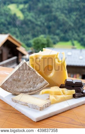 Cheese Collection, Swiss Cow Cheese Emmental, Tomme And Dark Chocolate And Mountains Village In Apls