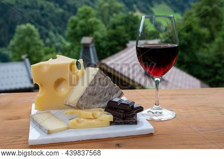 Cheese Collection, Swiss Cow Cheese Emmental, Tomme And Dark Chocolate, Glass Of Red Wine From Savoi
