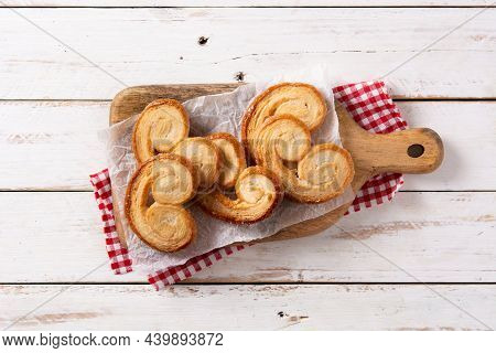 Palmier Puff Pastry In Plate On White Wooden Table
