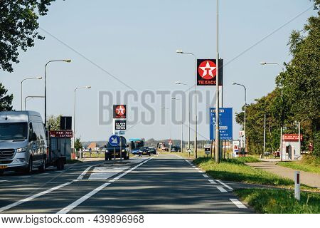 Texel, The Netherlands - Aug 27, 2019: Dutch Highway Street With Cars And Vans And Texaco Gas Statio