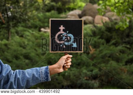 Woman Holding Chalkboard With Gender Symbols Outdoors, Closeup