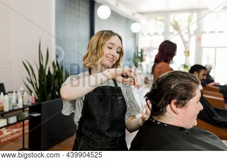 Hairstylist set the customer hair in a perm