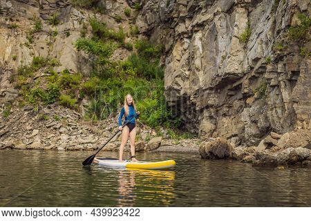 Young Women Having Fun Stand Up Paddling In The Sea. Sup. Red Hair Girl Training On Paddle Board Nea