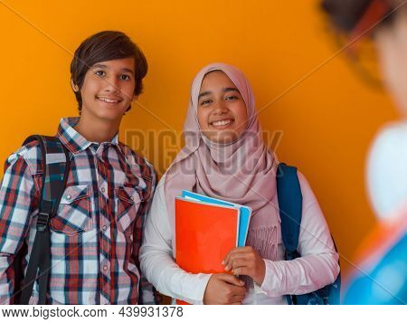 A group of Arab teenagers, a student team walking forward into the future and back to school the concept of a yellow background. The concept of successful education for young people. Selective focus