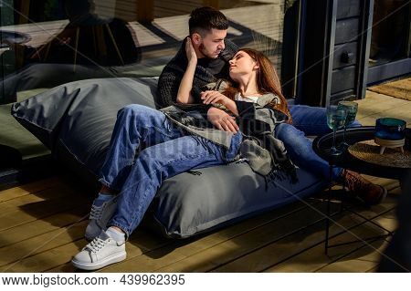 Portrait Of A Young Couple In The Backyard Near The House