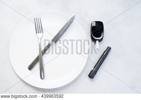 Diabetes Diet Planning Concept, Empty Plate With Fork, Knife And Glukemetr, Fasting Diet And Dieabet