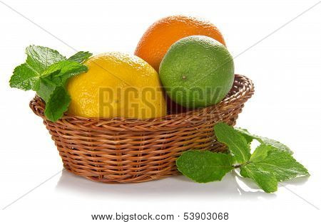 Lemon, lime, orange in a wicker basket