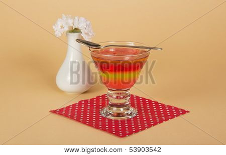 Glass with jelly and spoon on napkin