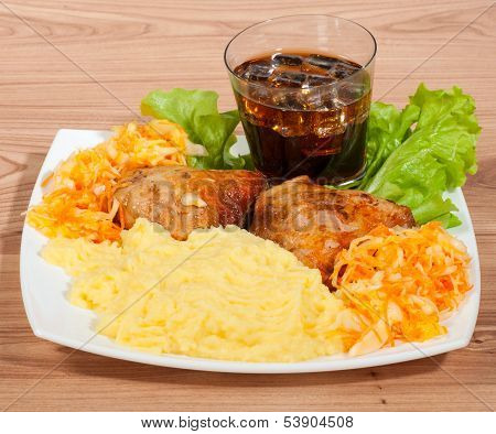 Grill Chicken With Mashed Potato, Cola, Ice  And Vegetables On A Plate