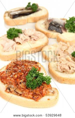 Tasty sandwiches with tuna and cod liver sardines different kinds of canned fish, isolated on white