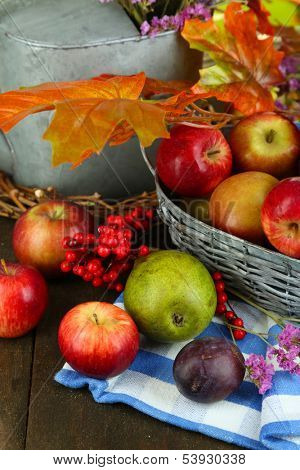 Juicy apples in basket on table close-up