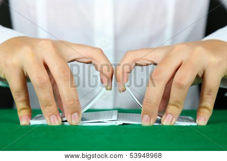 Playing cards in hands close up
