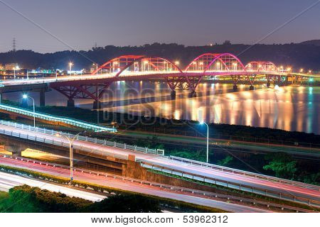Night scene of cars light at highway and interchange in famous Guandu Bridge, Taipei, Taiwan, Asia.