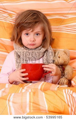 Little girl  sitting sick in bed
