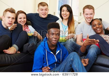 Group Of Friends Watching Television At Home Together