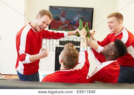 Group Of Sports Fans Watching Game On TV At Home