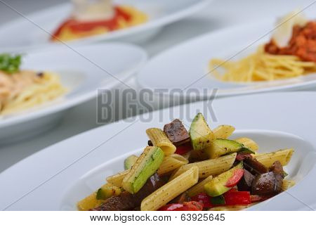 Pasta with shrimps, herbs and mashrooms isolated on white background in studio