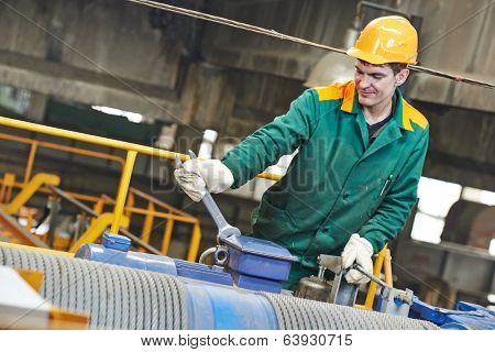 industrial worker with spanner at factory construction workshop