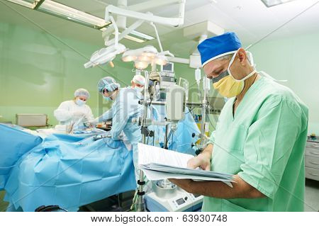 Male surgeon in uniform in front of cardiac surgery operation room at clinic