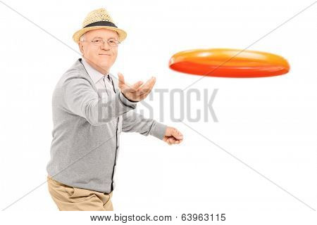 Senior man throwing a Frisbee disk isolated on white background