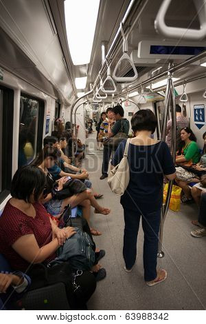 SINGAPORE - AUGUST 15: Passengers in the car subway Singapore. Singapore's subway , also known as MRT, started operating in 1987. It's network length is 130 kms, it has 87 stations and 4 lines. 