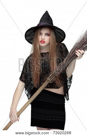 Young girl in witch costume with a broom