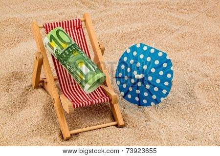 a deck chair with a euro banknote. symbol photo for saving on holiday and when traveling