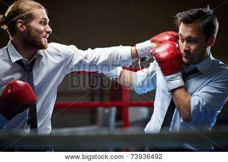 Competitive businessman giving his rival a facer