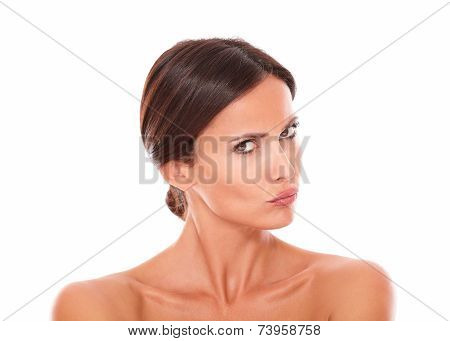Unsmiling Hispanic Female Looking At Camera