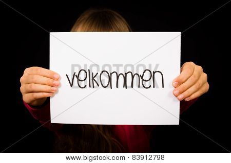 Child Holding Sign With Danish Word Velkommen - Welcome
