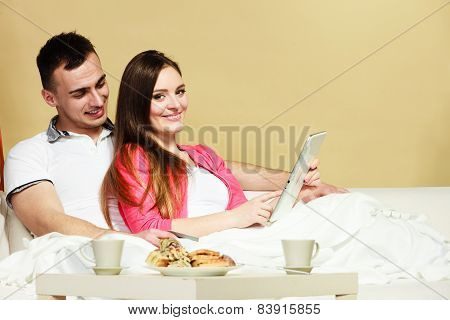 Young Couple With Tablet And Credit Card At Home