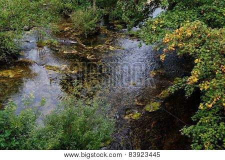 Surface of travertine pond in autumn
